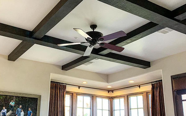 An image of Volterra’s rough sawn faux wood beams in an espresso finish.