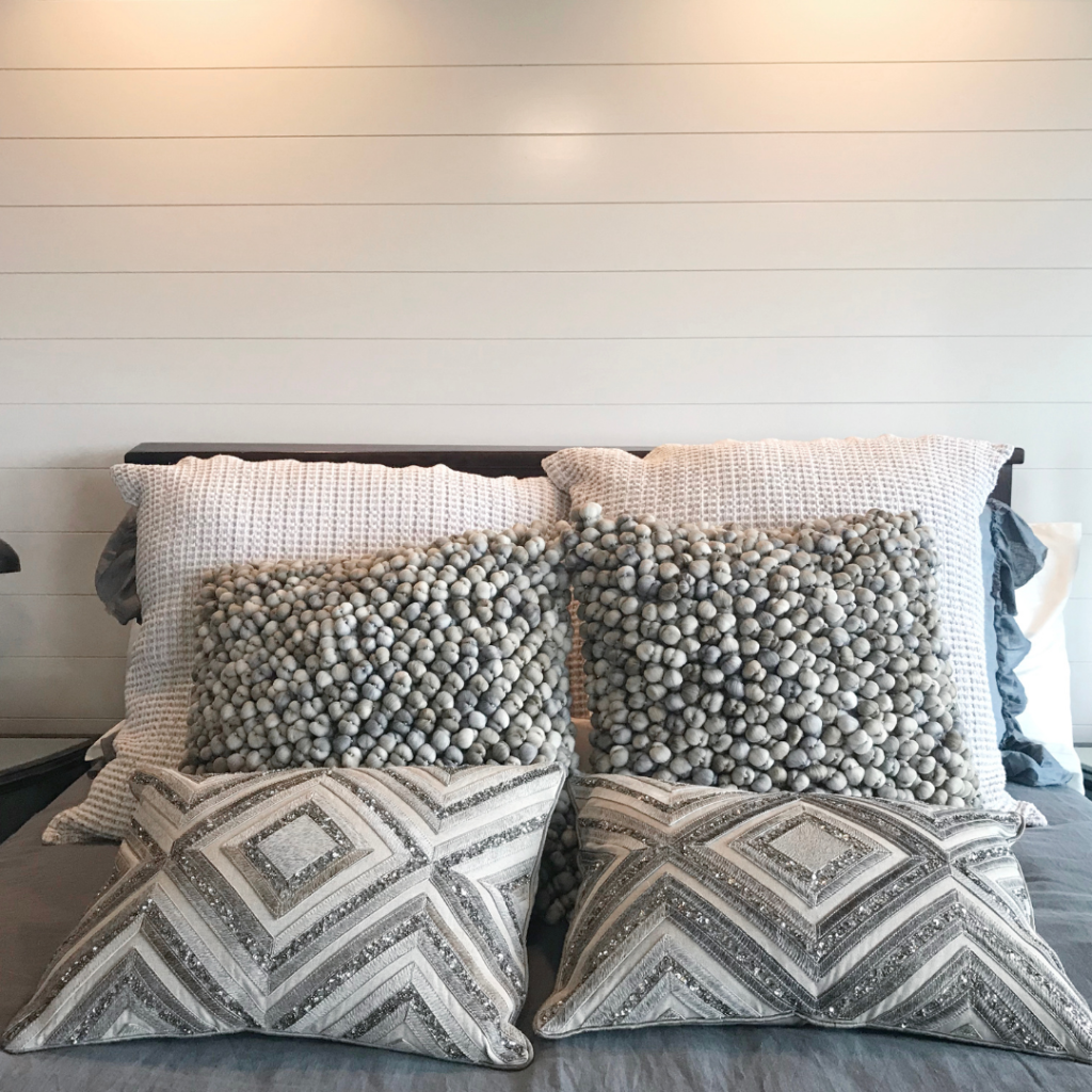 Wood plank headboard in a master bedroom