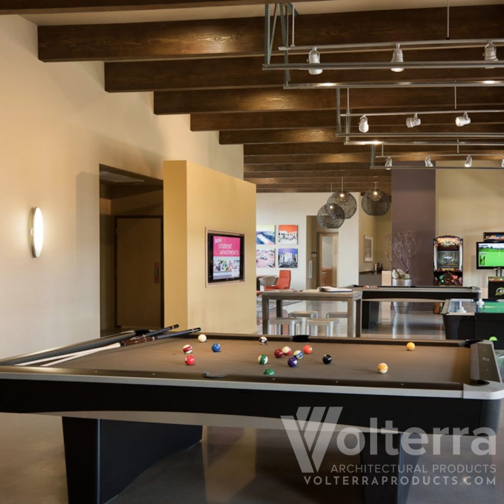 entertainment room with faux wood beams